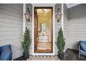Charming entryway with decorative sconces and petite potted trees, setting a welcoming tone at 2206 Weepoolow Trl, Charleston, SC 29407