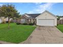 Well-maintained single-Gathering home with a manicured lawn, brick accents, and a two-car garage at 224 Market Hall St, Moncks Corner, SC 29461