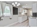 Bright kitchen featuring white cabinets, stainless appliances, granite countertops and light wood flooring at 2702 Decatur St, North Charleston, SC 29405