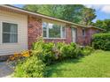 Close up of brick exterior with window, garden and front door with address number 2903 at 2903 Shadow Ln, North Charleston, SC 29406