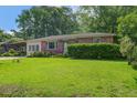Quaint single-story home with vibrant green lawn and lush landscaping enhancing its curb appeal at 2903 Shadow Ln, North Charleston, SC 29406