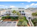 Charming condo featuring a balcony, well-maintained landscaping, and stairs to upper levels at 2942 Atrium Villa Dr # 42, Johns Island, SC 29455