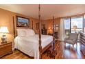 Main bedroom featuring a four-poster bed, hardwood floors, and views of the city at 330 Concord St # 8E, Charleston, SC 29401