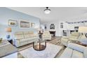 Open living area with comfortable seating and ample natural light, flowing into the kitchen at 3473 Plow Ground Rd, Johns Island, SC 29455