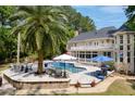 This home boasts a stunning backyard pool with a spa, surrounded by lush greenery and patio furniture at 3685 Colonel Vanderhorst Cir, Mount Pleasant, SC 29466