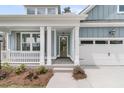 Inviting entryway with an elegant glass front door and two-car garage at 395 Wappoo Trace Ln, Summerville, SC 29486
