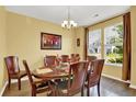 Formal dining room showcasing a decorative chandelier, natural light, and hardwood floors at 466 Gianna Ln, Goose Creek, SC 29445