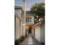 Stylish home featuring a brick chimney, white siding, and a stone pathway leading to a private entrance at 499 Lackland Ct, Mount Pleasant, SC 29464