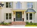 Stunning entrance with red brick steps, potted flowers, and a sophisticated door design with sidelight windows at 499 Lackland Ct, Mount Pleasant, SC 29464