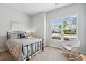 Cozy bedroom featuring carpet flooring, a comfortable bed, a chair, and a bright window at 516 Tidewater Chase Ln, Summerville, SC 29486