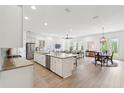Bright, open-concept living space featuring a modern kitchen with stainless steel appliances and hardwood flooring at 516 Tidewater Chase Ln, Summerville, SC 29486