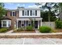 Lovely townhome boasts a mix of brick and siding, framed by mature trees and greenery at 655 Swinton Ct, Mount Pleasant, SC 29464