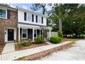 Inviting townhome showcases a blend of brick and siding, complemented by lush green shrubs at 655 Swinton Ct, Mount Pleasant, SC 29464