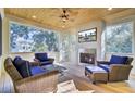 Cozy sun room with fireplace, comfortable seating, and natural light streaming through the windows at 828 Bridge Point Cir, Mount Pleasant, SC 29464