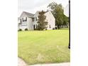 Well-maintained two-story home with a spacious front yard and attached two-car garage at 9229 N Moreto Cir, Summerville, SC 29485