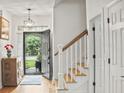 Bright foyer featuring hardwood floors, staircase with white railings, and an open entryway to the home at 106 Chedburg Dr, Goose Creek, SC 29445