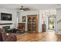 Inviting living room featuring a brick fireplace, wood floors, built-in bookcase, and plenty of seating at 106 Chedburg Dr, Goose Creek, SC 29445