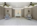 Relaxing front porch with ceiling fans and seating, perfect for enjoying the outdoors at 1061 Law Ln, Mount Pleasant, SC 29464