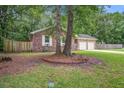 Attractive brick home with a two-car garage, surrounded by mature trees and a well-maintained yard at 110 Terry Ave, Summerville, SC 29485