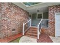 Welcoming brick front porch with stairs, white railings, and visible house number at 110 Terry Ave, Summerville, SC 29485