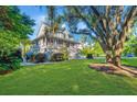 Beautiful two-story home with well-kept lawn, lush greenery, and a partially visible pool at 1447 Headquarters Plantation Dr, Johns Island, SC 29455