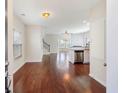 Inviting entryway showcasing gleaming hardwood floors and an open floor plan with abundant natural light at 1484 Milldam Pass, Johns Island, SC 29455