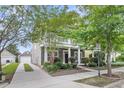 Lovely two-story home with a driveway leading to a detached garage and a well-manicured front lawn at 1523 Nautical Chart Dr, Charleston, SC 29414