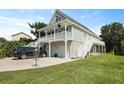 Charming coastal home featuring a spacious driveway, double garage, and a welcoming upper porch at 1625 Teal Marsh Rd, Charleston, SC 29412