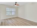 Bright bedroom with hardwood floors, neutral walls, a ceiling fan, and a large window at 163 Darcy Ave, Goose Creek, SC 29445