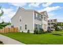 Side view of a gray two-story home with well-maintained lawn and garden at 2267 Kemmerlin St, Johns Island, SC 29455