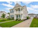 Beautiful two-story home with a double porch, garage, and lush landscaping at 2267 Kemmerlin St, Johns Island, SC 29455