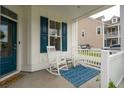 Inviting porch featuring rocking chairs, blue rug, and a view of the neighborhood at 2267 Kemmerlin St, Johns Island, SC 29455