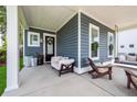 Spacious covered porch furnished with cozy seating arrangements at 290 Woodland Oak Way, Summerville, SC 29485
