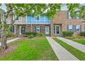 Charming townhomes with brick and siding exteriors, featuring well-maintained lawns and inviting walkways at 2927 Cathedral Ln, Charleston, SC 29414