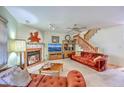 Cozy living room with fireplace, plush sofas, and stairway to the upper level at 2927 Cathedral Ln, Charleston, SC 29414