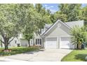 Beautiful home featuring a two-car garage, black shutters, and a well-manicured lawn at 350 Arlington Dr, Charleston, SC 29414