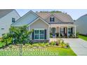 Inviting single-story home with beautifully landscaped front yard and covered porch at 366 Tupelo Lake Dr, Summerville, SC 29486