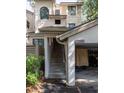 Exterior view of a two-story home with a covered golf cart parking area and stairs to the living quarters at 410 Yacht Harbor Ct # 410, Isle of Palms, SC 29451
