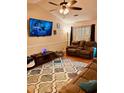 Inviting living room with a large screen TV, ceiling fan, comfortable sofa, and accent rug at 429 Stephanie Dr, Goose Creek, SC 29445