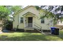 Spacious backyard with lush green grass, mature trees and a covered back porch at 47 Oswego St, Charleston, SC 29403