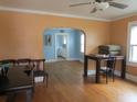 Spacious living room with hardwood floors, arched doorway, and ceiling fan at 47 Oswego St, Charleston, SC 29403