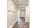 Inviting entryway with wood-look flooring, white walls, and decorative trim details at 505 Shady Maple St, Moncks Corner, SC 29461