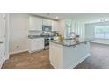 Modern kitchen with granite countertops, stainless steel appliances, and a spacious island at 505 Shady Maple St, Moncks Corner, SC 29461