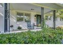 Inviting front porch with a comfortable rocking chair, plants, and stylish decor for relaxing outdoors at 5332 Parkside Dr, North Charleston, SC 29405