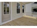 Covered porch entrance featuring white trim, wood floors, and natural light at 617 Du Bois Dr, Johns Island, SC 29455