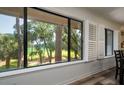 Large windows showcase picturesque golf course views at 855 Club Cottage Rd, Edisto Island, SC 29438