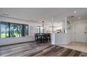 Open floorplan with wood floors, large windows, and an adjacent kitchen at 855 Club Cottage Rd, Edisto Island, SC 29438