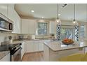 Bright, modern kitchen with white cabinets, granite countertops, and stainless steel appliances at 8621 Connor Ct, North Charleston, SC 29406