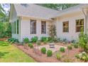 The house has well-manicured landscaping, featuring a variety of plants and flowers, complementing the home's exterior design at 974 Cliffwood Dr, Mount Pleasant, SC 29464