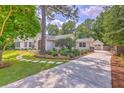 Beautiful home with lush landscaping, a private driveway, and a detached garage, creating a charming and inviting curb appeal at 974 Cliffwood Dr, Mount Pleasant, SC 29464